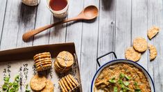 a bowl of soup and crackers on a wooden table