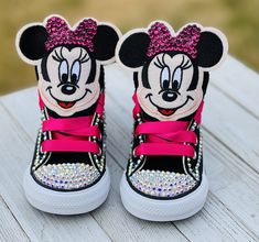 a pair of minnie mouse high top sneakers with pink bows and sequins on them