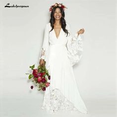 a woman in a white dress with flowers on her head is posing for the camera