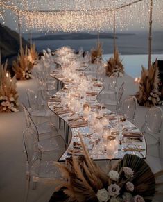 a long table is set up with candles and flowers for an elegant dinner or reception