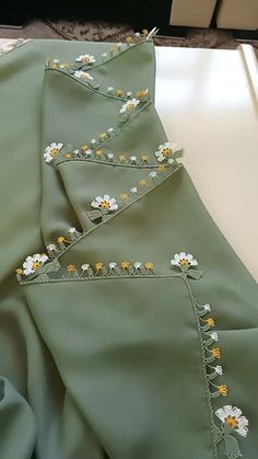 two green sheets with yellow and white flowers on them are laying next to each other