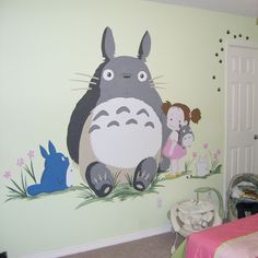 a child's bedroom with a totoro mural on the wall