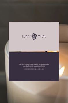 a candle with a business card on it