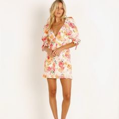 Bright Floral Dress In Linen-Blend Fabric Detailed With Delicate Ruffles. Plunging Neckline Puff Elbow-Length Sleeves Banded Cuffs With Bow Concealed Zipper Back Paneled Waist Ruffle Hem Cotton Lining Linen/Viscose/Spandex Dry Clean Imported Size & Fit Fitted Silhouette About 30" From Shoulder To Hem Pink Floral V-neck Dress For Brunch, Pink V-neck Floral Dress For Brunch, Pink Floral Mini Dress For Brunch, Pink Floral Dress For Date Night, Pink V-neck Mini Dress For Garden Party, Bright Floral Dress, Lemon Dress, For Love & Lemons, Love And Lemons