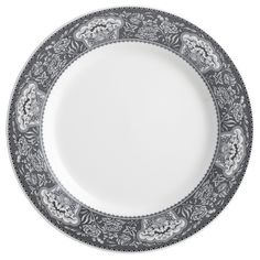 a white and black plate with floral designs on the rim, against a white background