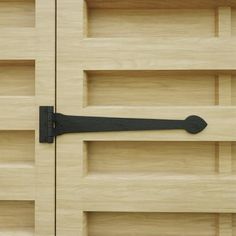 a close up of a wooden door with black handles