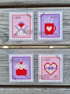 three cross stitch coasters with hearts on them