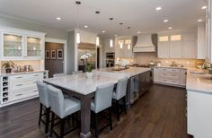 a large kitchen with an island in the middle and lots of counter space on one side