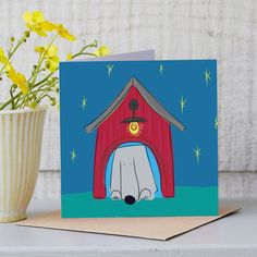 a card with a dog in front of a red barn and yellow flowers next to it