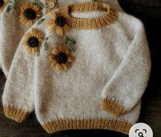 two knitted sweaters with sunflowers on them