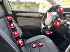 the steering wheel cover is decorated with red and white beads