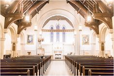 an empty church with pews and stained glass windows