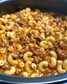 a bowl filled with macaroni and cheese on top of a table