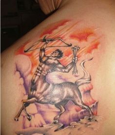 a man with a tattoo on his back holding an arrow