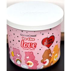 an ice cream container with bears and hearts on it's lid, sitting on a table