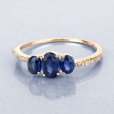 "14K Gold Ring, Blue Sapphire, Blue Sapphire 3 Stone Ring, Genuine Sapphire, Sapphire and Diamond Ring, Royal Blue, September Birthstone Sparkling blue sapphire stones make this elegant 3 stone ring into something extra special. The 3 stone ring is crafted from 14k yellow gold with fine finish and definitely allows you to showcase your unique style amongst the crowd. With 0.98 carats, this ring has a subtle sparkle which makes it a clear winner! Product Details: 14K Yellow Gold Stone Details: Bl 3 Stone Sapphire Ring, Fine Jewelry Blue Three Stone Jewelry, Fine Jewelry Three-stone Sapphire Ring, Blue Multi-stone Sapphire Promise Ring, Blue Sapphire Multi-stone Promise Ring, Multi-stone Sapphire Birthstone Ring, Fine Jewelry Blue Diamond Ring With Three Stones, Blue Sapphire Three-stone Birthstone Ring, Blue Three Stone Birthstone Ring