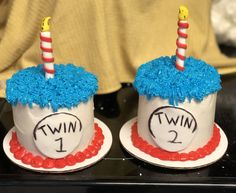 two cupcakes that have candles in them