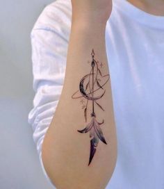 a woman's arm with a tattoo on it that has an arrow and feathers