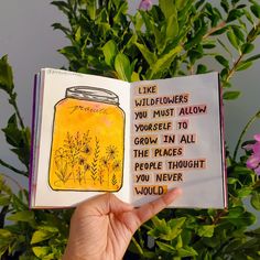 a person holding up an open book with flowers in it and the words like wildflowers you must allow yourself to grow in all the places people thought you never would