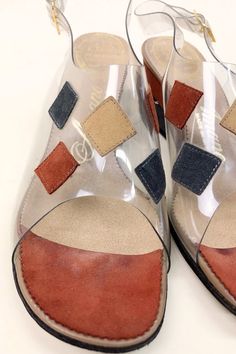 "DETAILS * the perfect mod wedge sandal * vinyl front with sewn on suede patches * peep toe * adjustable sling back * classic 60s mid century colors ERA: 1960s LABEL: Amano, Carefree Last SIZE: Marked an 8 but fit like a 7.5 Narrow width of ball foot: 3\" insole: approx 9.75\" heel: 2.5\" MATERIAL: vinyl, suede COLOR: clear, rust, beige, gray CONDITION: Excellent vintage condition. DISCLAIMER: Be aware that vintage shoes come in As Is condition. These shoes have been checked and tested to see if Retro Open Toe Wedge Sandals For Beach, Retro High Heel Wedge Sandals, Retro Wedge Heel Beach Sandals, Retro Wedge Sandals For The Beach, Retro Wedge Heel Sandals For Beach, Retro Leather Wedge Sandals, Retro Leather Wedge Heel Sandals, Retro Leather High Heel Wedge Sandals, Retro Leather Open Toe Wedge Sandals