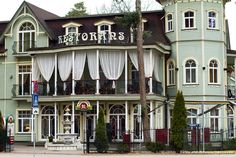 a large building with white curtains on it