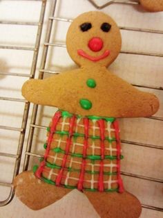 a gingerbread man is decorated with green and red icing