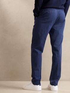 Inspired by a pair from the Banana Republic archives, these sumptuous chino pants are made from soft cotton with a special enzyme wash for plush hand feel, and a pleated front with tapered leg for a look that's always polished.  TAPERED FIT: Mid rise Formal Relaxed Fit Chinos With Tapered Leg, Formal Relaxed Fit Tapered Leg Chinos, Tapered Cotton Dress Pants For Work, Classic Tapered Chinos For Workwear, Tapered Cotton Chinos For Business Casual, Classic Tapered Chinos With Pockets, Classic Tapered Cotton Pants, Relaxed Fit Tapered Leg Chino Dress Pants, Business Casual Tapered Cotton Chinos