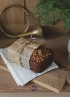 a loaf of bread wrapped in brown paper