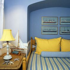 an image of a bedroom with blue walls and yellow pillows