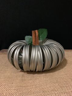 a metal coil pumpkin sitting on top of a table