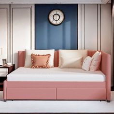 a living room with a couch and a clock on the wall above it's headboard