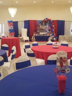 a room filled with tables and chairs covered in red, white and blue decorations