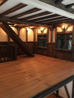 an empty room with wooden floors and beams