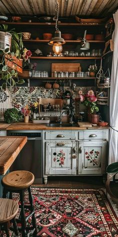 an old fashioned kitchen with lots of pots and pans on the shelves above the sink