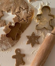 cookies and cookie cutters on a white surface