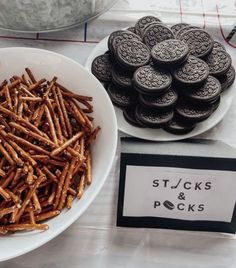 there are many cookies and crackers in the bowl next to each other on the table