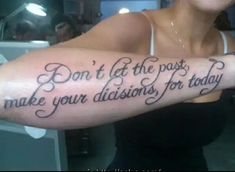 a woman with a tattoo saying don't let the past make your decision for today