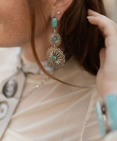 Holy moly these earrings are stunning! They are a 3.5", 3 Tier Burnished Silver and Turquoise Flower Concho Earrings on Turquoise Post earring! Made by west + co out of Texas! These complete your dressy outfit and we have so many necklaces that will style perfect with them! Concho Earrings, Authentic Turquoise Jewelry, Dressy Outfit, Grit And Grace, Holy Moly, Wild Rag, Turquoise Flowers, Top Graphic Tees, Dressy Outfits