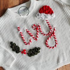 a knitted sweater with candy canes on it