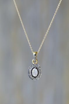 Welcome to Nadean Designs, Genuine Rose-cut Rainbow Moonstone Gemstone Solitaire Necklace set in oxidized sterling silver (.925) with 24 karat gold vermeil finish. A Pave diamond halo surrounds the outside of the rose-cut rainbow moonstone solitaire and a single row of diamonds is set on the front side of the bail. Pendant size: 10mm long (excluding bail) by 9mm wide by 4mm width. The oval rainbow moonstone diamond pendant hangs from 14 karats gold-filled dainty cable chain with a lobster closur Solitaire Necklace, 24 Karat Gold, Solitaire Necklaces, June Birthstone, Oxidized Sterling Silver, June Birth Stone, Diamond Halo, Diamond Gemstone, Rainbow Moonstone