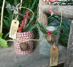 two baskets with christmas decorations hanging from them on a wooden bench in front of plants