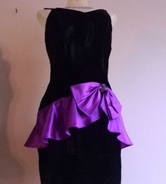 "This is a  fitted bombshell style dress made with luscious black velvet material and trimmed with a stunning purple satin peplum and a large bow trimmed in the center with a rhinestone brooch. Spaghetti straps and figure hugging style this is a classic retro 50s fashion that is revived every so often as is very flattering and a stunning style. Dress closes with a 16\" side zipper that works smooth as new Fabric is 100 percent rayon crushed velvet outer materi100 percent acetate satin lining. Th Purple Velvet Fitted Dress, Fitted Purple Velvet Dress, Purple Velvet Dress For Party, Purple Velvet Party Dress, Elegant Purple Dress With Bow, Elegant Purple Velvet Dress, Formal Purple Velvet Dress, Black Velvet Cocktail, Dress Peplum