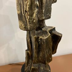 a bronze sculpture sitting on top of a wooden table