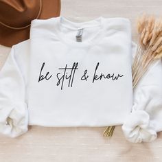 Be Still & Know That I Am God, Psalm 46:10. Grab this sweatshirt to remind you of God's blessings.Ideal for any situation, a unisex heavy blend crewneck sweatshirt is pure comfort.The classic fit along with the crew neckline deliver a comfy wearing experience with a clean-cut style. Inspirational Cotton Crew Neck Sweatshirt, Inspirational White Crew Neck Sweatshirt, Inspirational Crew Neck Sweatshirt In Relaxed Fit, God's Blessings, I Am God, Psalm 46 10, Psalm 46, Clean Cut, Cut And Style