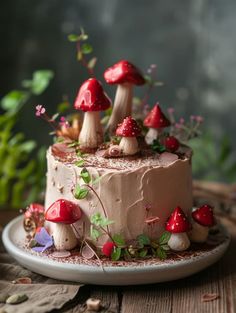 a cake with mushrooms on it sitting on top of a table next to flowers and leaves