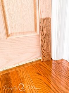 an open door with wood flooring in front of it