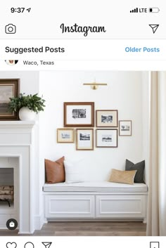 a living room filled with furniture and framed pictures on the wall above a fire place