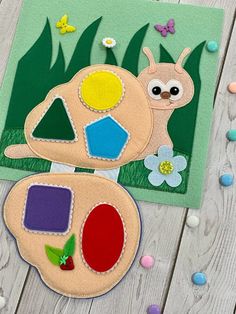 two felt animals sitting on top of a wooden table