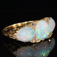 "I'm always on the lookout for marvelous opal rings, and I often come across 3 and 5 stone varieties in the very typical English Victorian fashion, but I have to admit that when I saw this particular ring my jaw just about hit the floor. Once I had lifted said jaw and tucked it back neatly into place, I had no choice but to slip this large and luscious beauty onto my finger and bring it home with me. This is, without a doubt, the biggest, boldest and most fabulous example of a 3 stone ring I hav Opal And Diamond Ring, Edwardian Jewelry, Ancient Jewelry, European Cut Diamonds, Multi Stone Ring, Spring Green, Glasses Accessories, Opal Rings, Vintage Colors