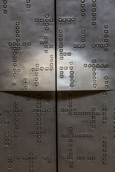 two metal doors with squares and numbers on them